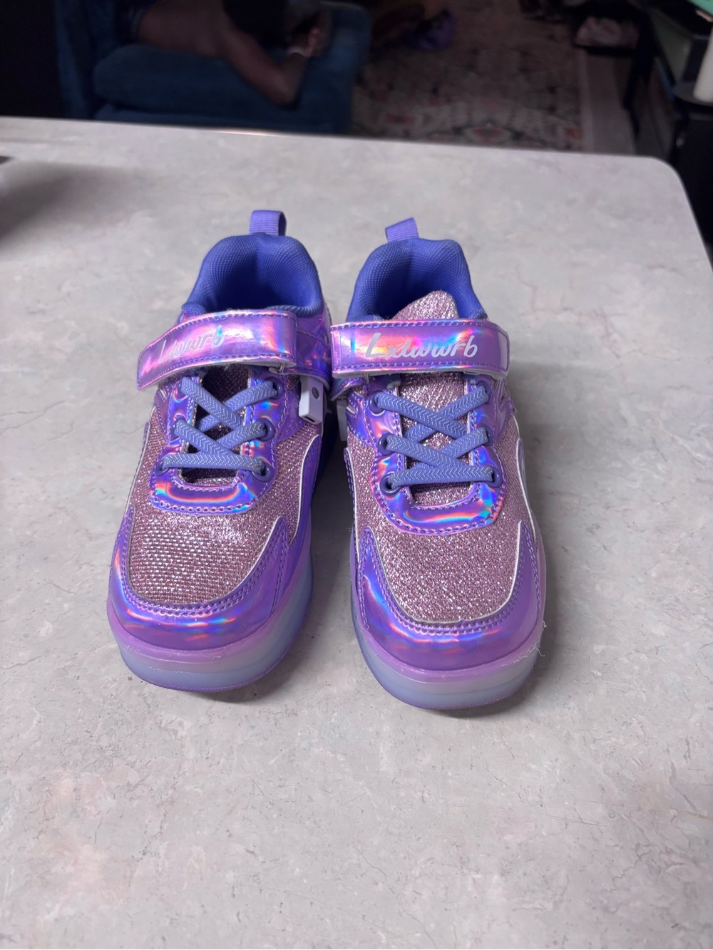 Girls Purple Iridescent Light-Up Sneakers with 4 wheels inside.